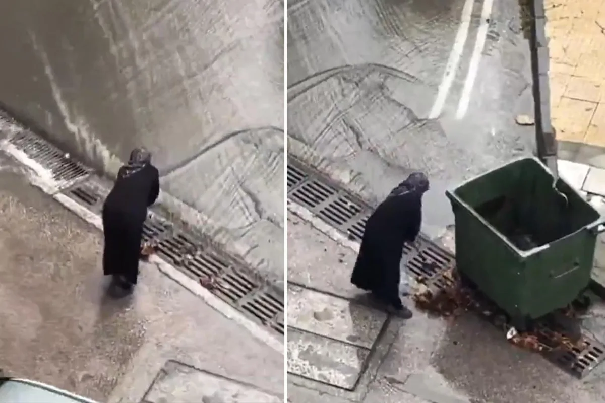 Belediye ekiplerini beklemeyen yaşlı kadın mazgalları bastonuyla temizledi